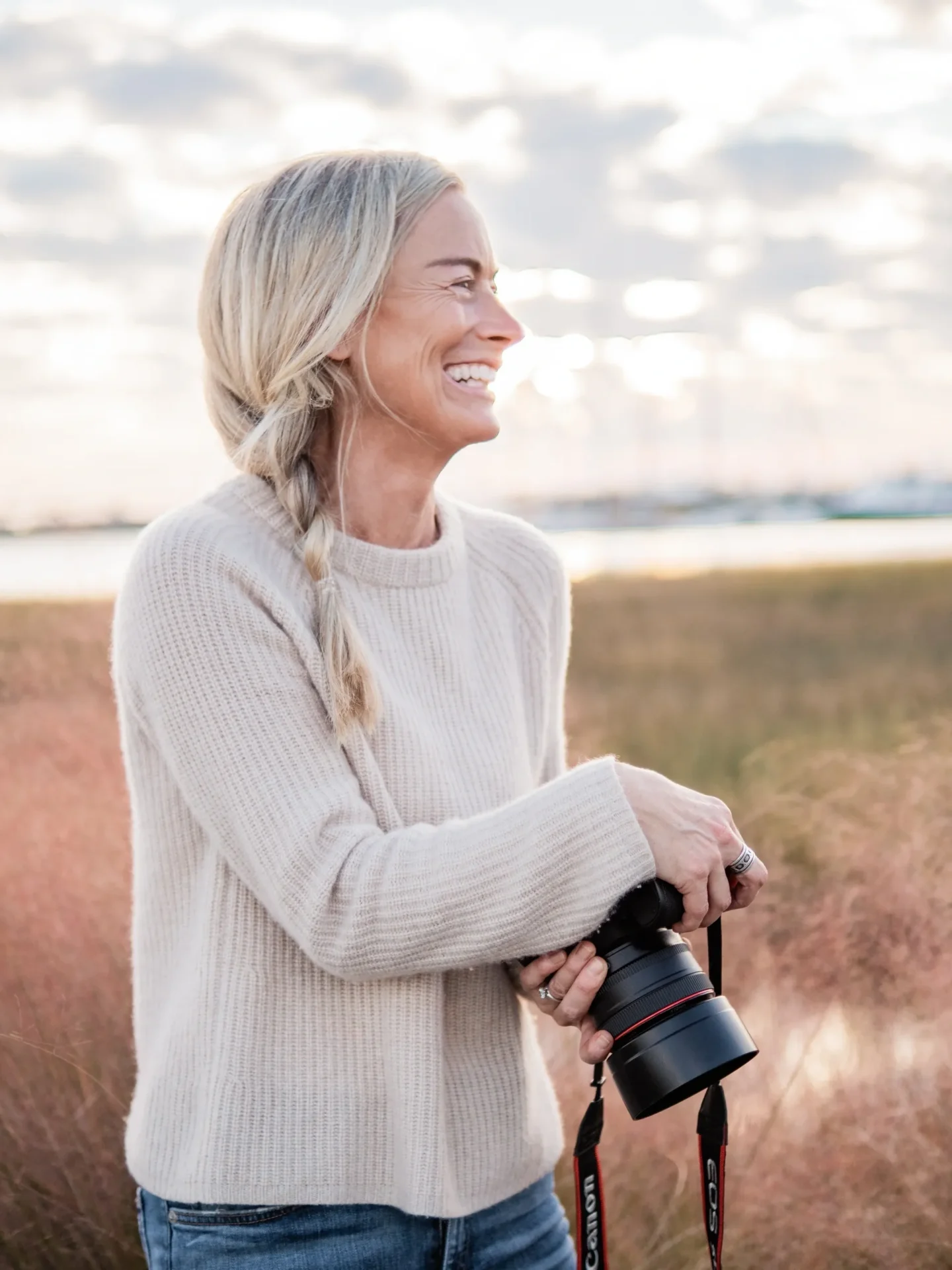 A woman holding a camera in her hand.