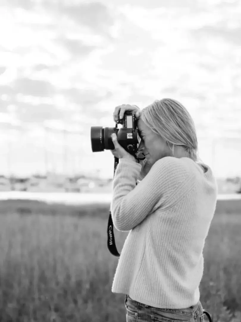 A woman is taking pictures of the sky