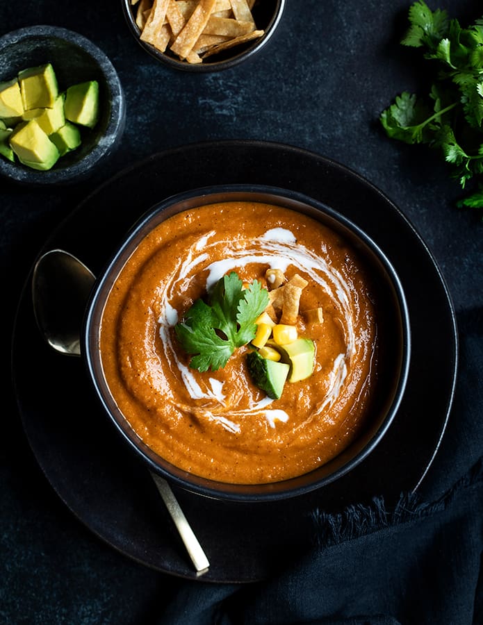 Tomato soup with avocado, cilantro, and cream.